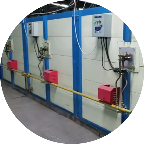 Industrial control panels with wiring and components mounted on a blue and white wall, with connected cables and switches.