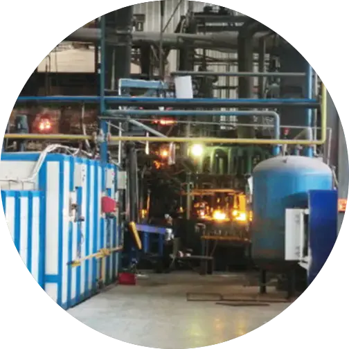 A factory scene showing an industrial setup with machinery for producing glass containers, featuring pipes, tanks, and glowing equipment.