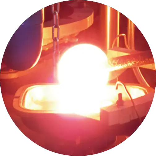 Bright molten glass being processed in a high-temperature furnace, showing the intense heat involved in glass production.