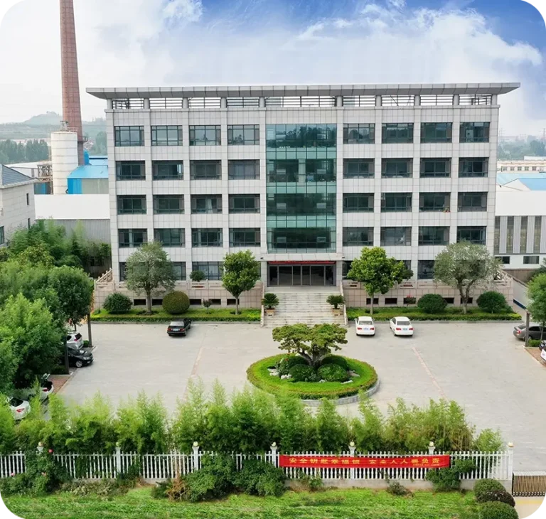 Front view of a multi-story office building with large windows, landscaped parking area with trees, and several cars parked.