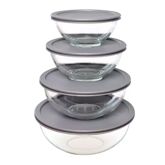 Four stacked glass bowls of varying sizes with gray lids, suitable for kitchen storage and organization.