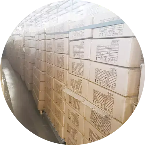 Stacks of labeled corrugated boxes neatly arranged in a warehouse, illustrating efficient storage or shipping organization.
